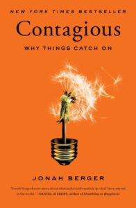 Book cover with orange background and a dandelion in the base of a light bulb